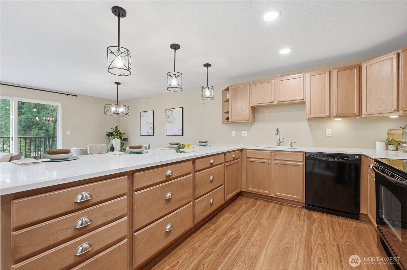 700 Front Street South, Unit E206 Issaquah, WA 98027 - Photo 3 of 32 a kitchen with cabinets wooden floor and stainless steel appliances