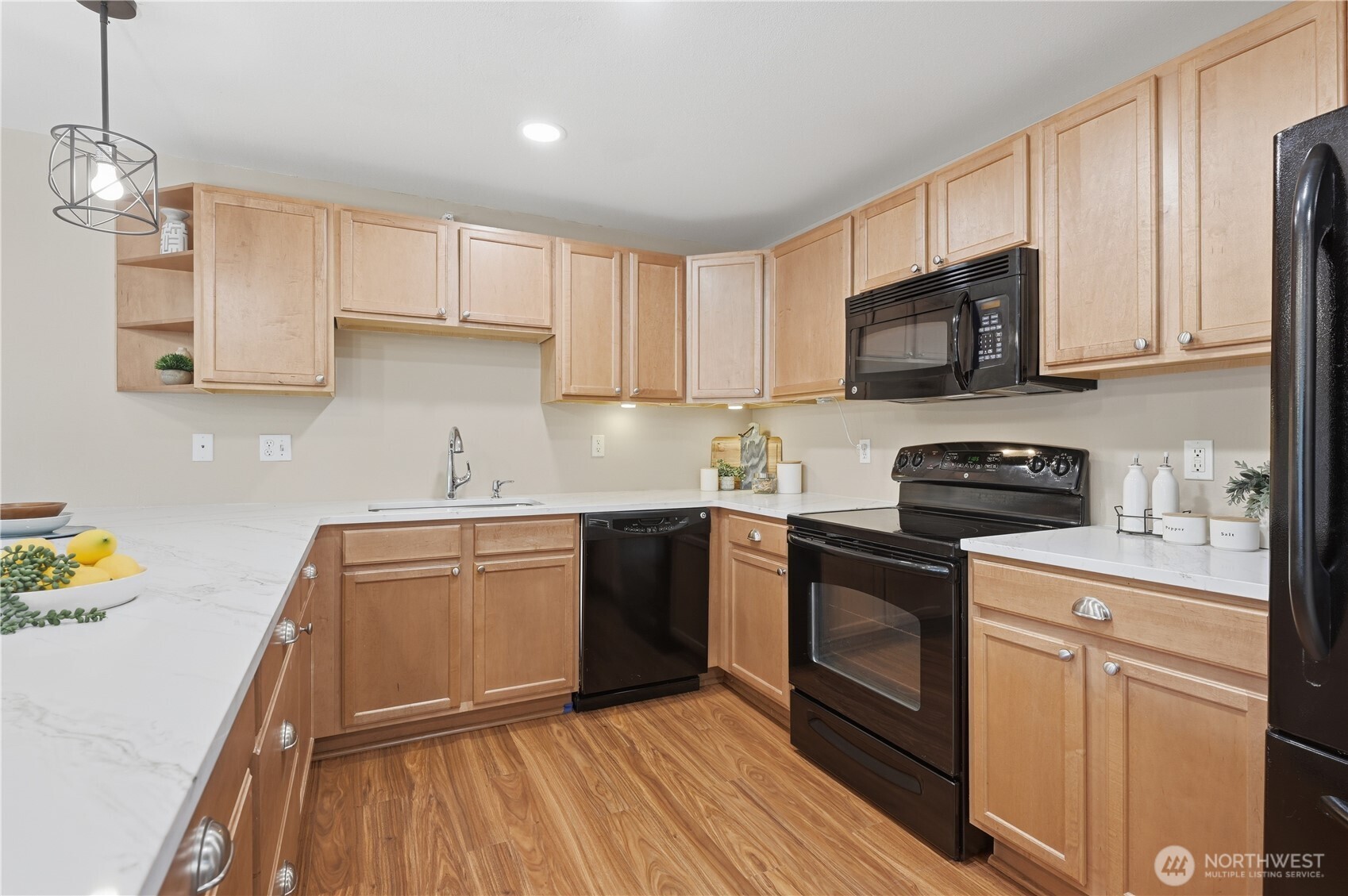 700 Front Street South, Unit E206 Issaquah, WA 98027 - Photo 5 of 32 a kitchen with granite countertop a sink dishwasher a stove and a microwave oven with cabinets
