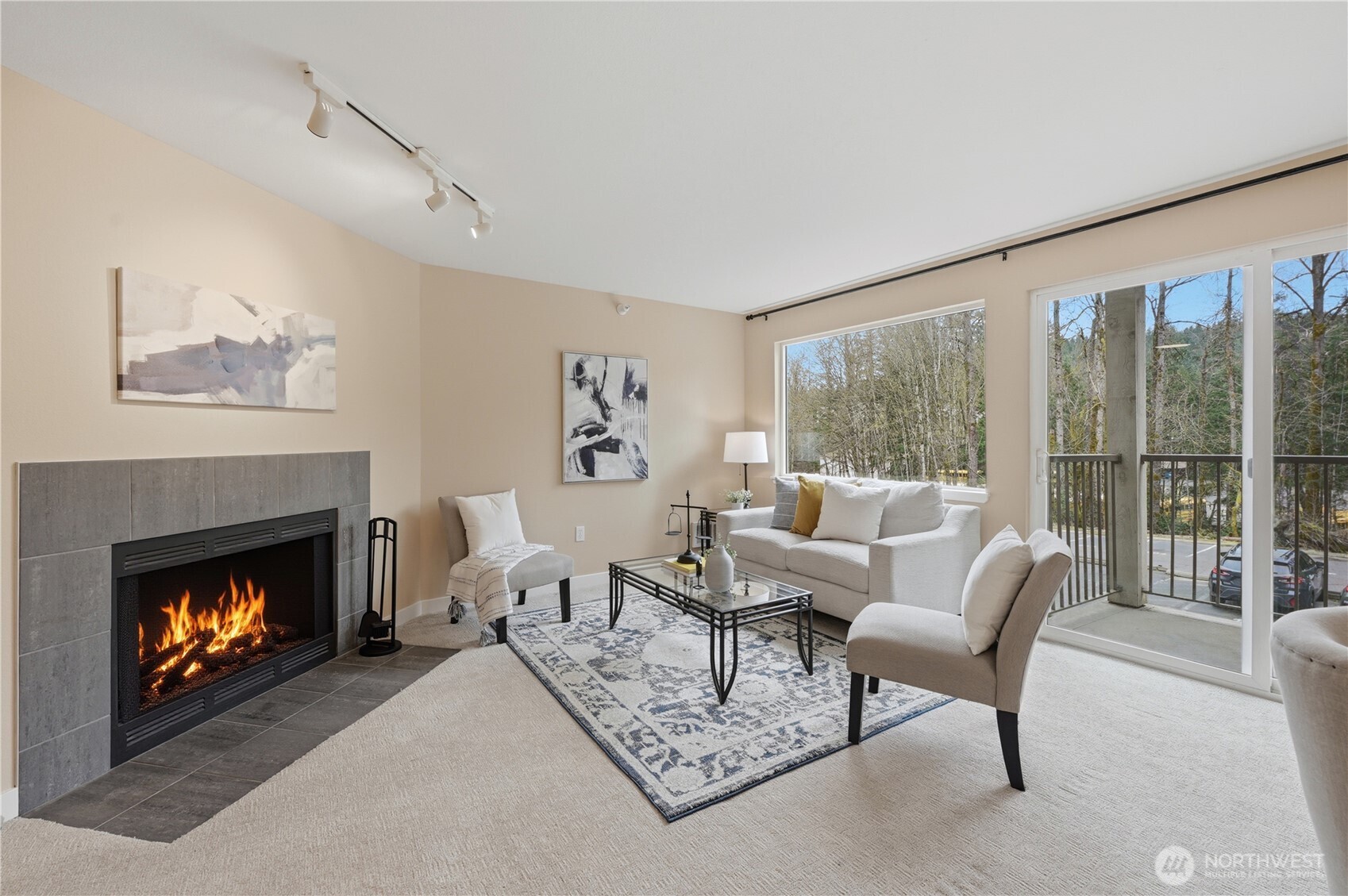 700 Front Street South, Unit E206 Issaquah, WA 98027 - Photo 7 of 32 a living room with furniture a fireplace and a large window