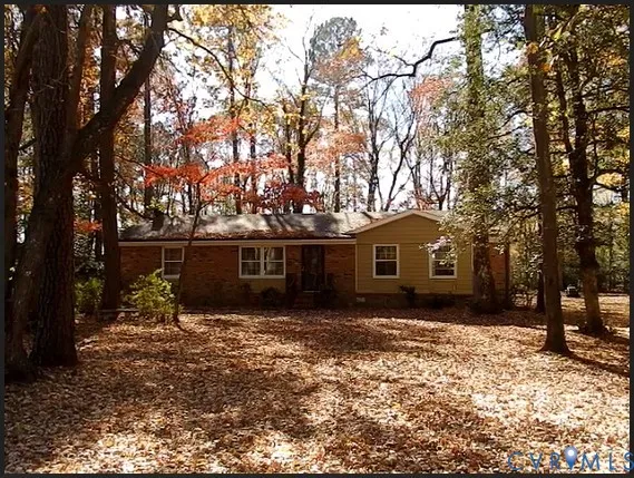 a front view of house with yard and trees