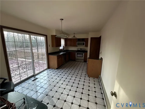 a kitchen with a sink a stove a refrigerator and cabinets