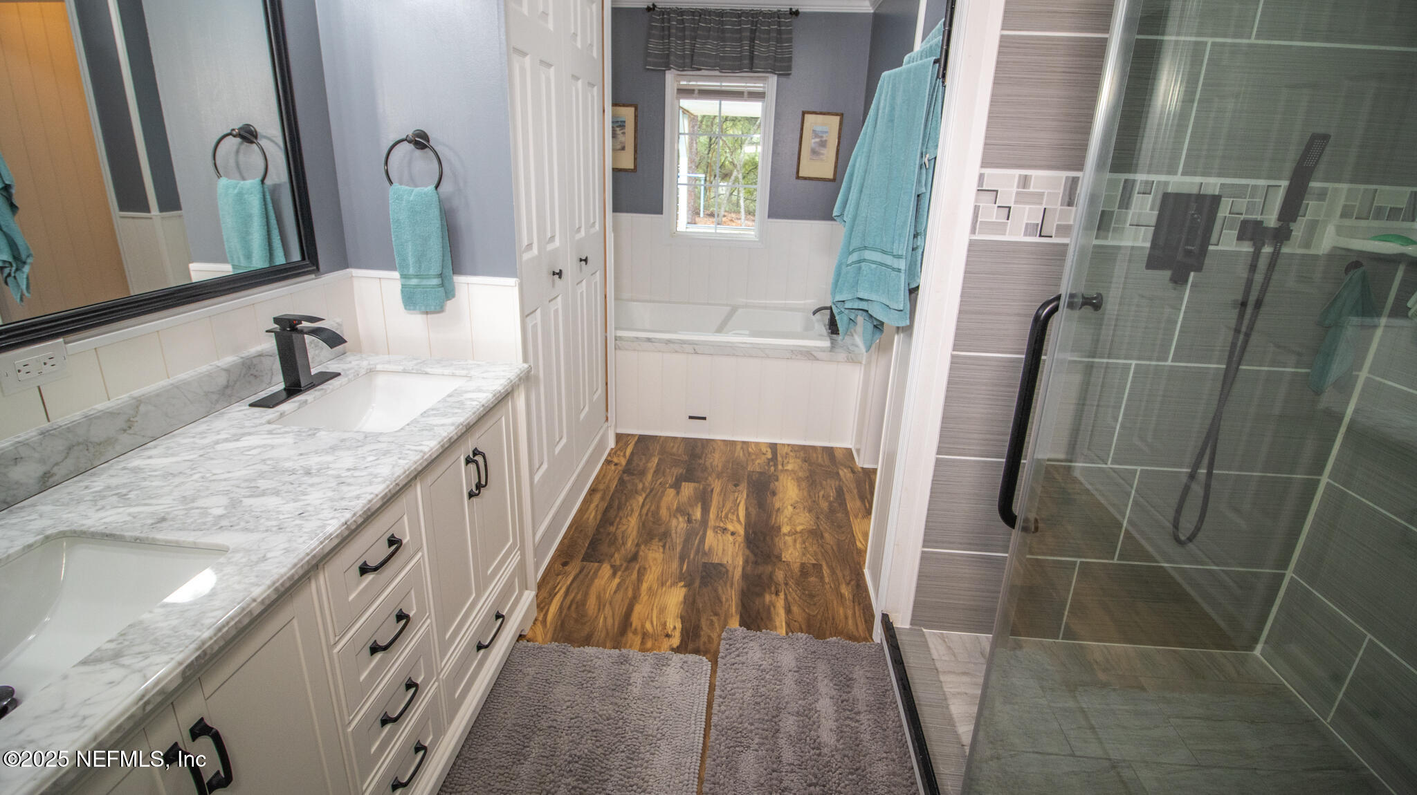 7110 Immokalee Road Keystone Heights, FL 32656 - Photo 12 of 36 a bathroom with a granite countertop sink a mirror and shower
