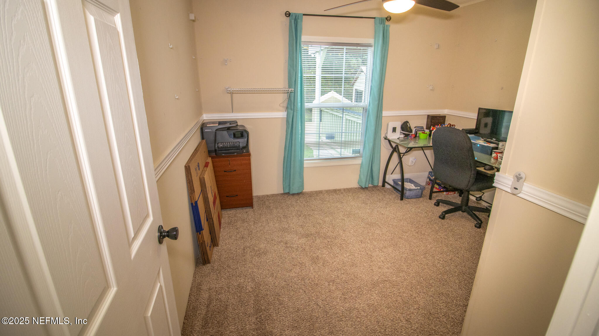 7110 Immokalee Road Keystone Heights, FL 32656 - Photo 17 of 36 a view of a workspace with furniture and a window