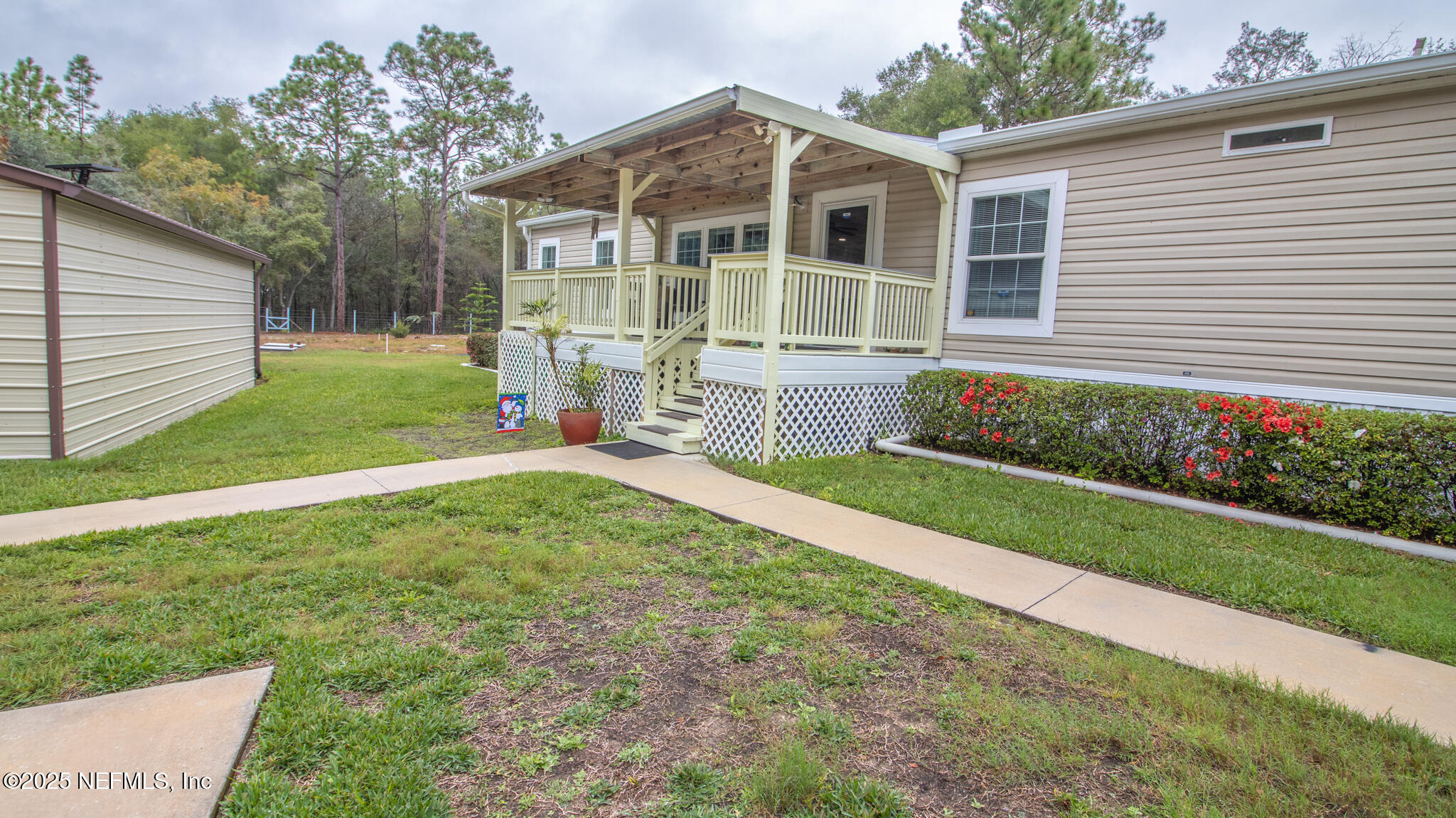 7110 Immokalee Road Keystone Heights, FL 32656 - Photo 2 of 36 a view of a house with a yard and sitting area