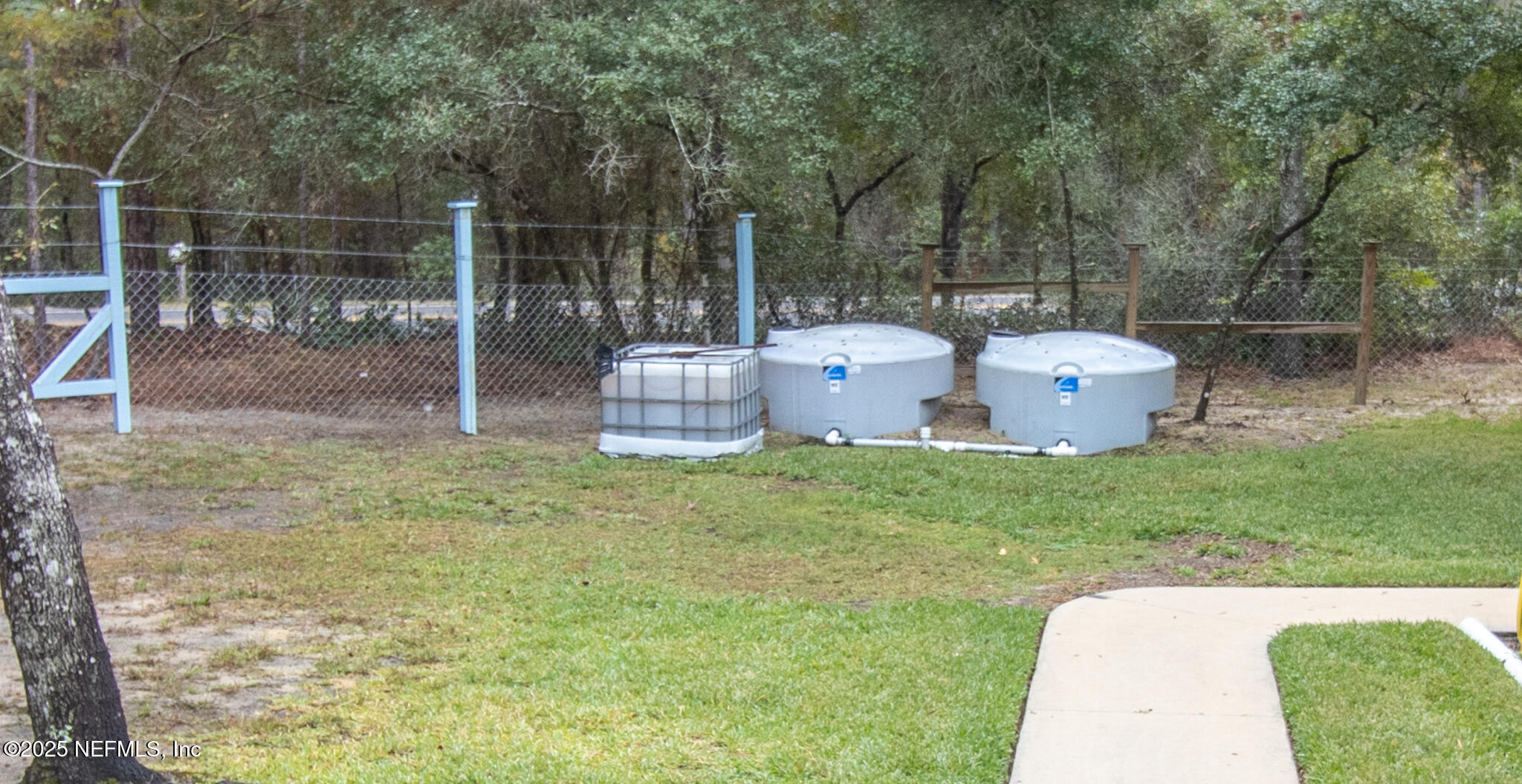 7110 Immokalee Road Keystone Heights, FL 32656 - Photo 36 of 36 a view of a backyard with two chair and a potted plant