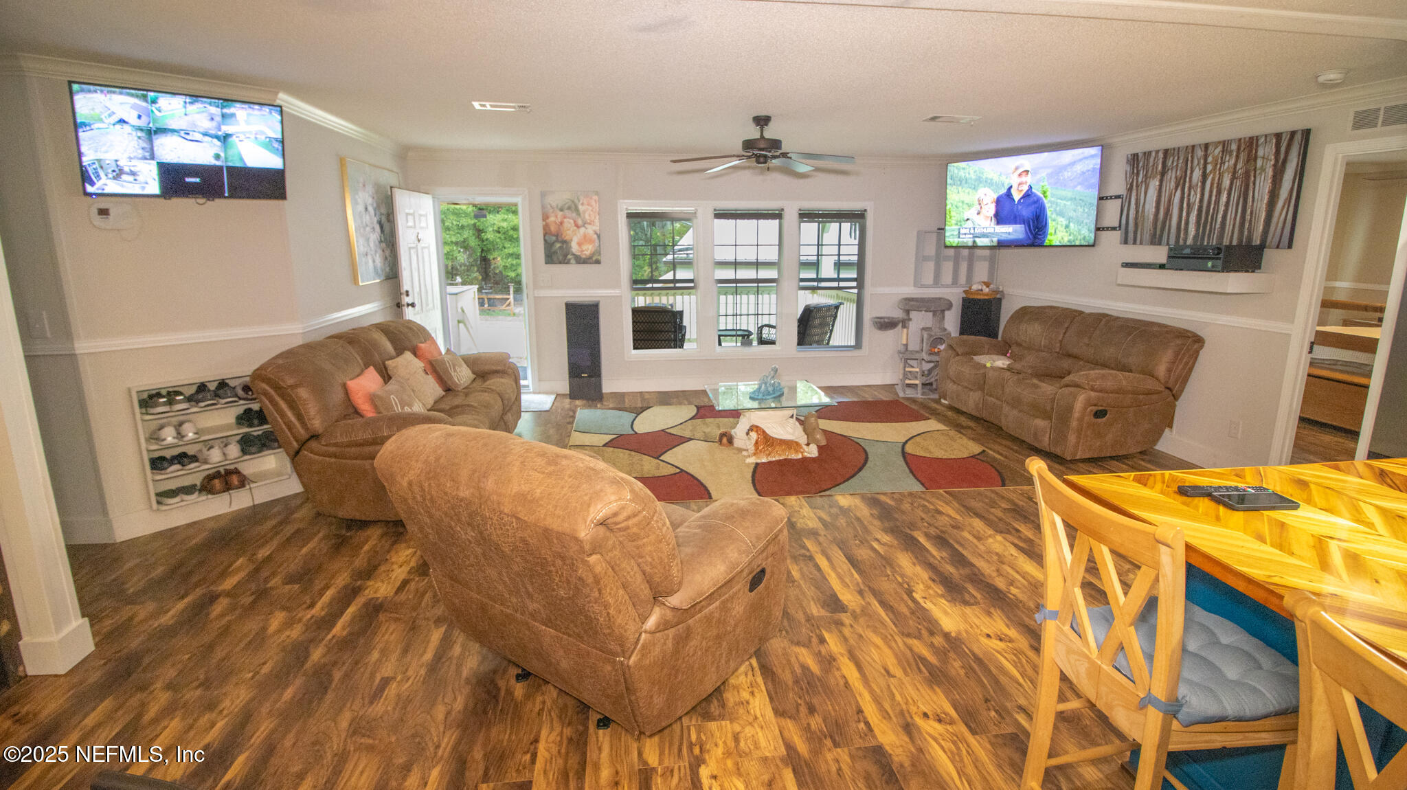 7110 Immokalee Road Keystone Heights, FL 32656 - Photo 5 of 36 a living room with furniture a flat screen tv and a dining table