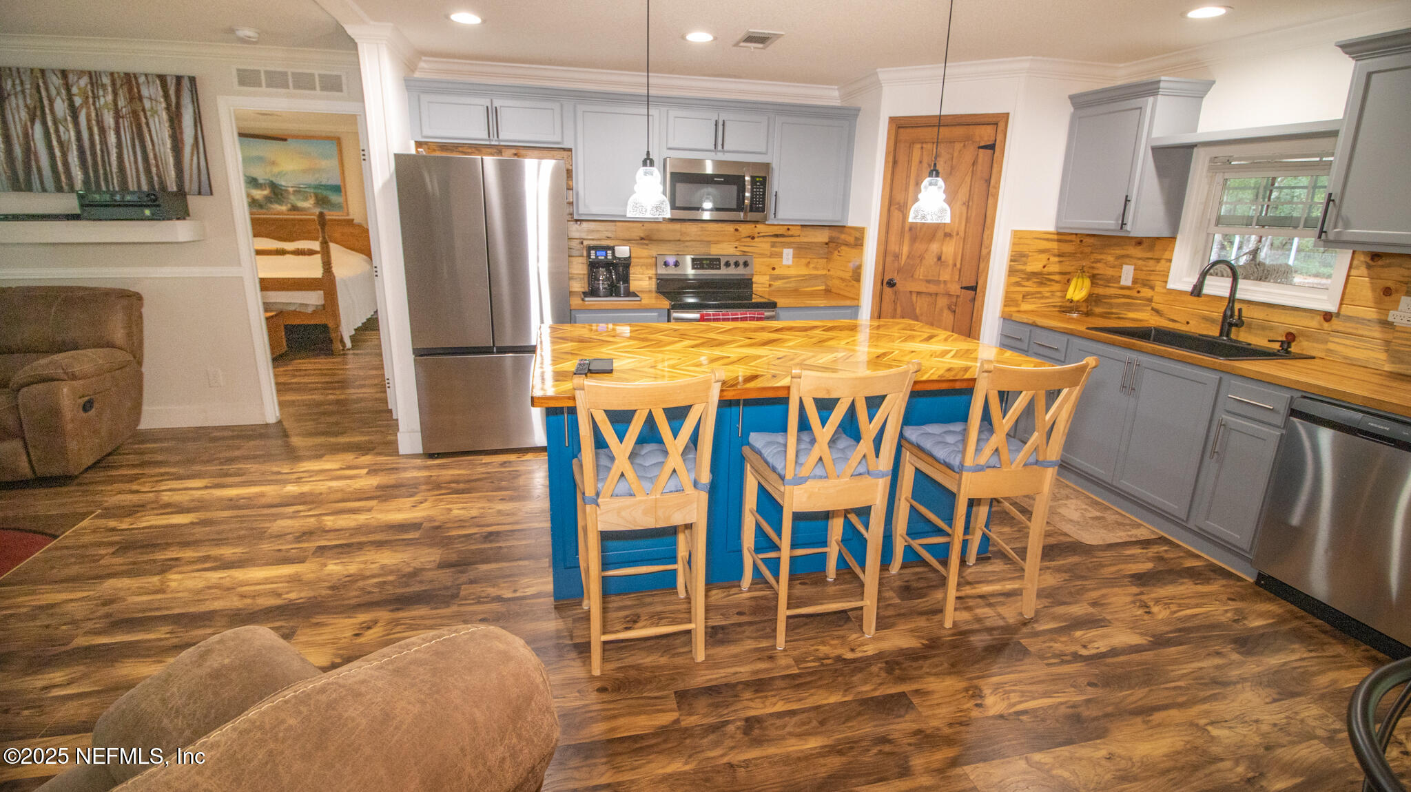 7110 Immokalee Road Keystone Heights, FL 32656 - Photo 6 of 36 a dining area with stainless steel appliances kitchen island granite countertop a dining table chairs sink and cabinets