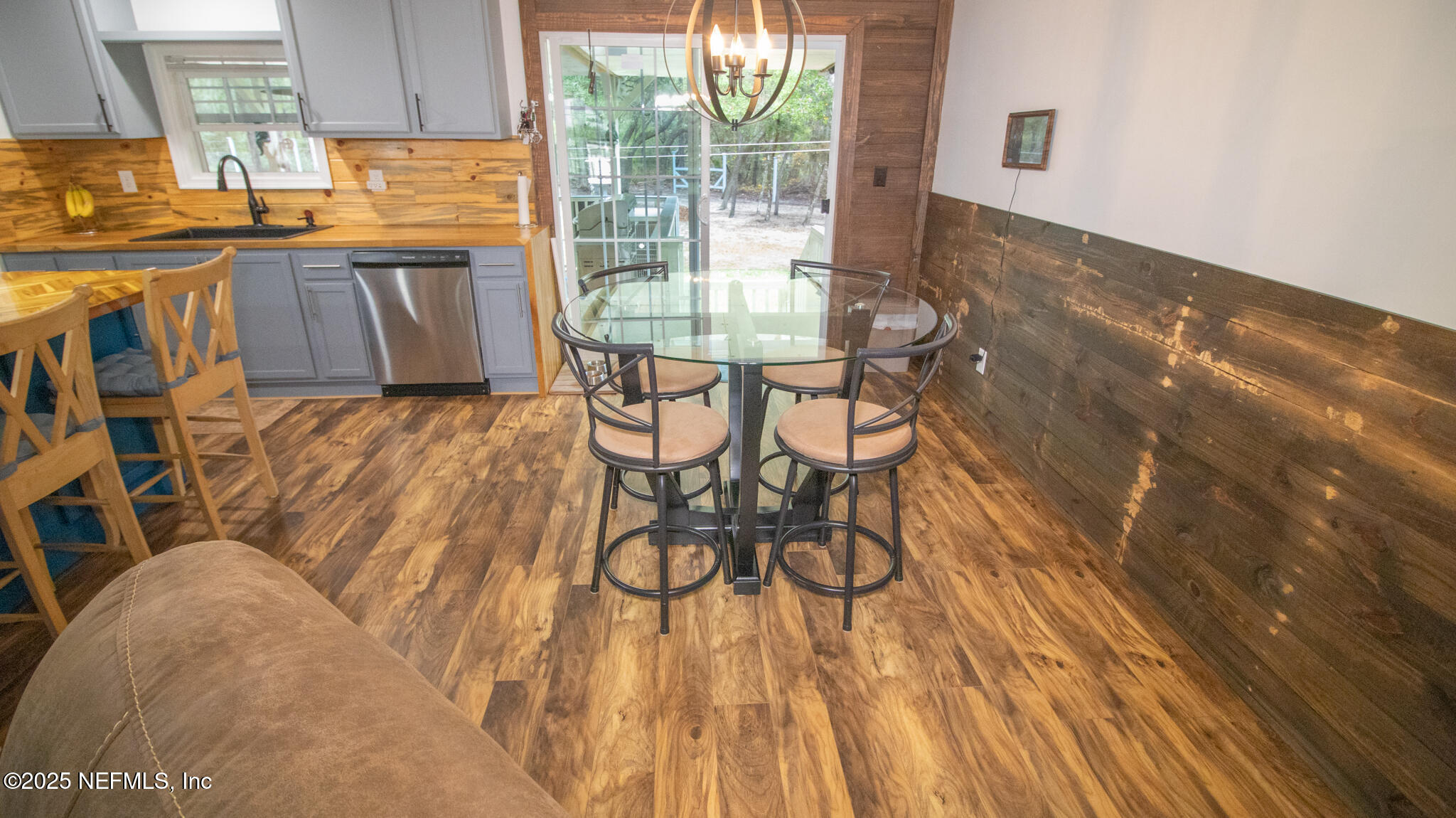 7110 Immokalee Road Keystone Heights, FL 32656 - Photo 7 of 36 a view of a dining room with furniture and wooden floor