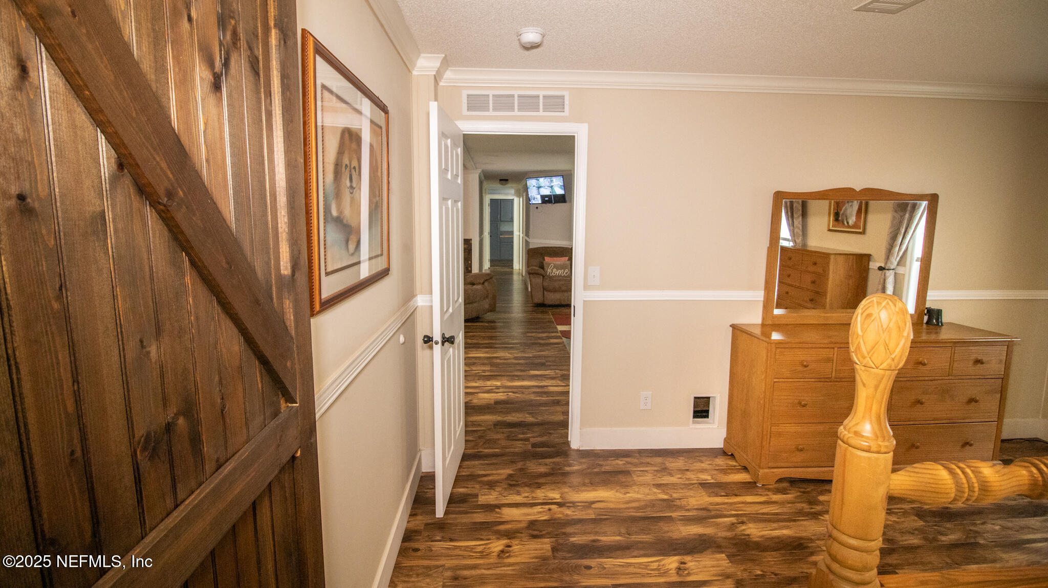 7110 Immokalee Road Keystone Heights, FL 32656 - Photo 9 of 36 a view of a hallway with wooden walls and door