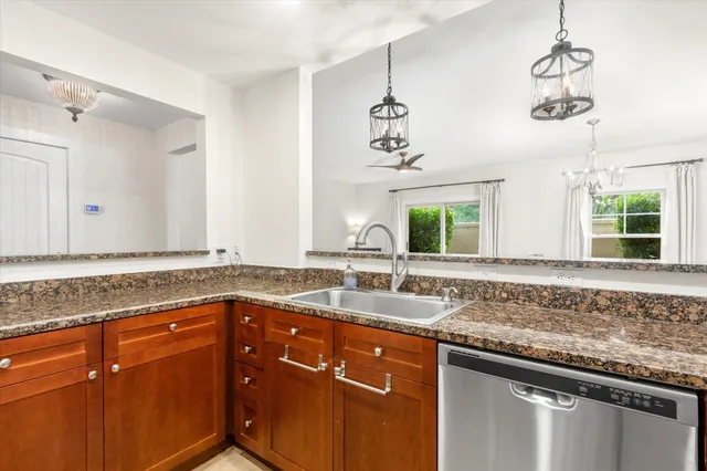 a bathroom with a granite countertop sink and a window