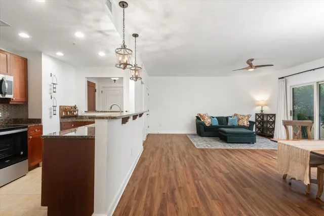 a kitchen with sink refrigerator and microwave