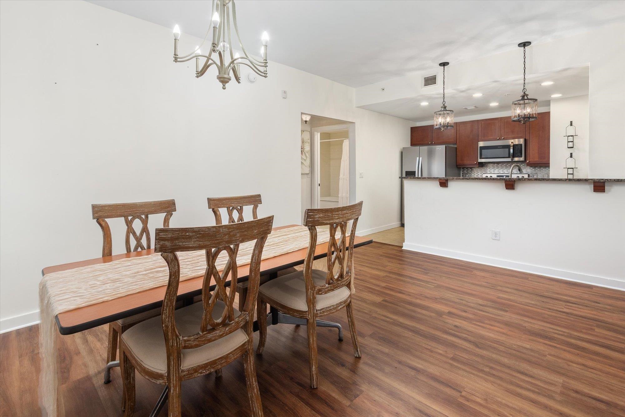 955 Registry Boulevard, Unit 105 St. Augustine, FL 32092 - Photo 15 of 30 a view of a dining room with furniture and wooden floor
