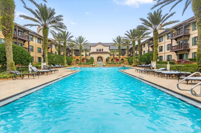 a swimming pool with outdoor seating and yard