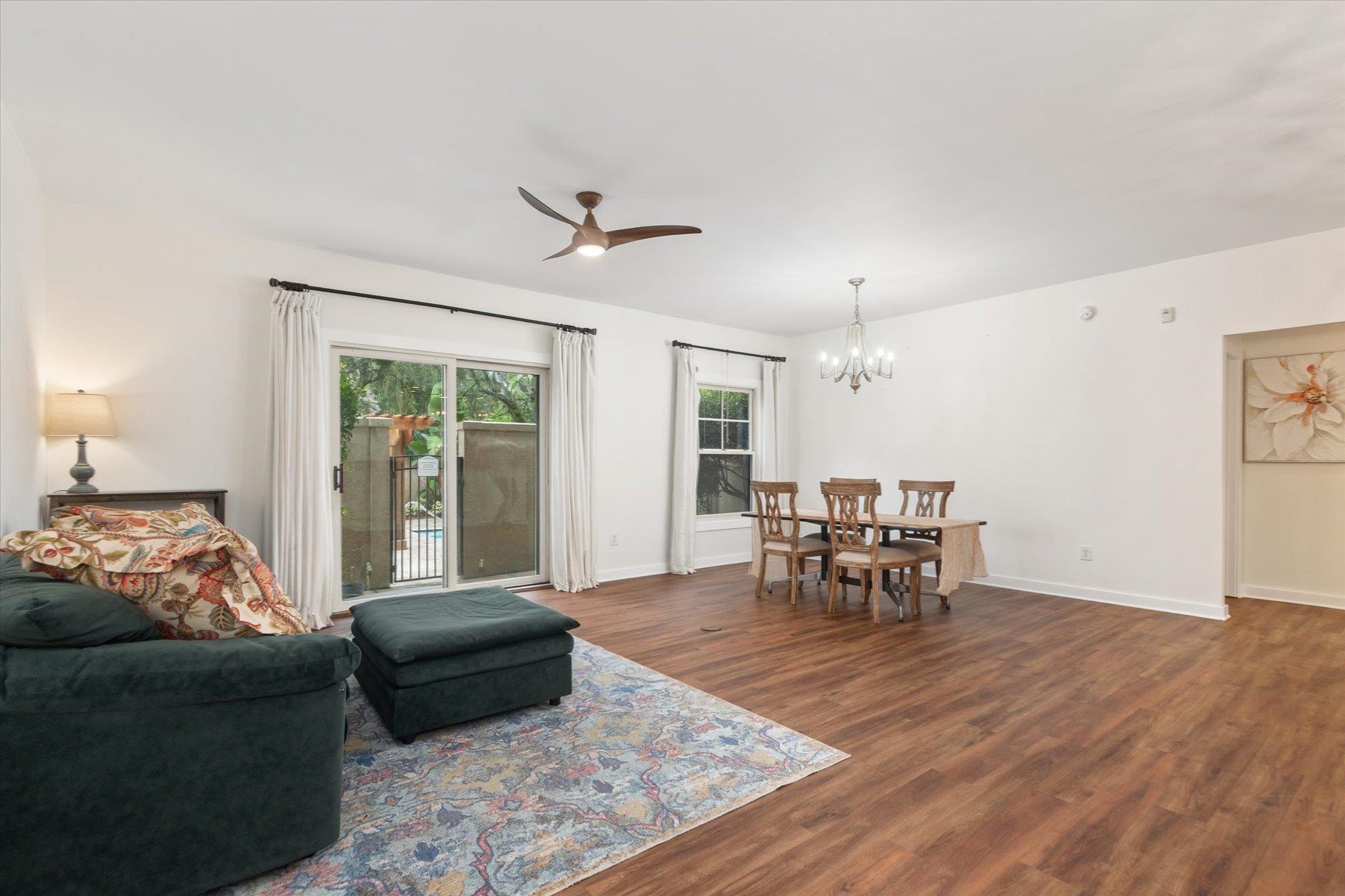 955 Registry Boulevard, Unit 105 St. Augustine, FL 32092 - Photo 5 of 30 a living room with furniture and a dining table with garden view