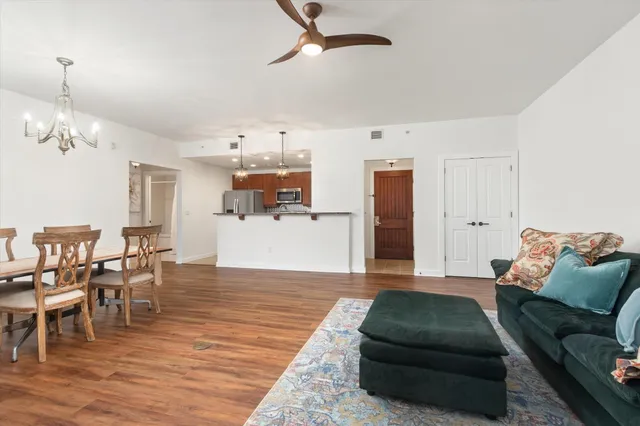 a living room with furniture and a wooden floor