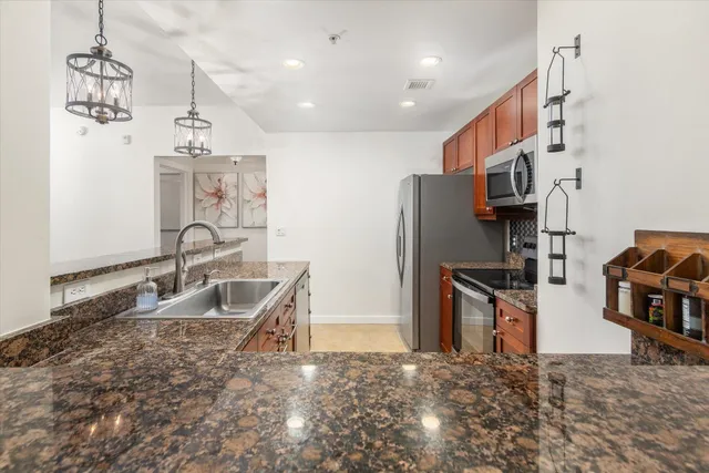 a kitchen with refrigerator sink and cabinets