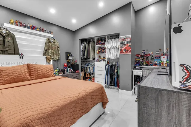 a bedroom with a bed and a dresser