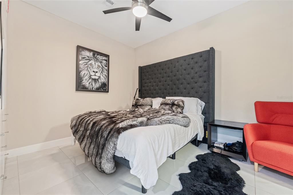 150 East Robinson Street, Unit 601 Orlando, FL 32801 - Photo 13 of 23 a bedroom with a bed and dresser