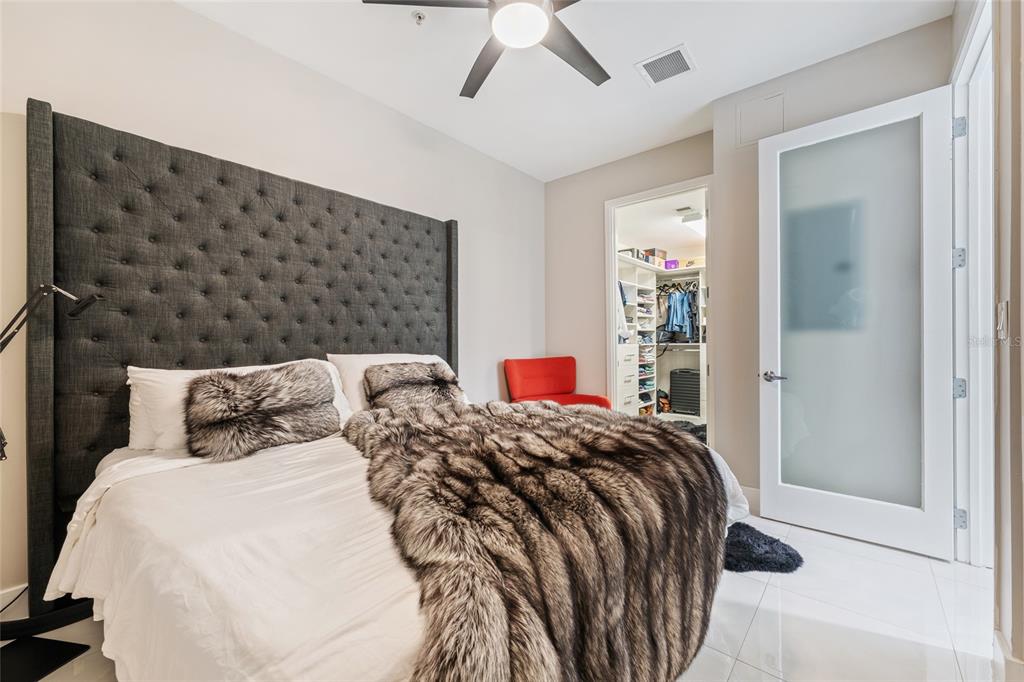 150 East Robinson Street, Unit 601 Orlando, FL 32801 - Photo 14 of 23 a bedroom with double bed and a large mirror