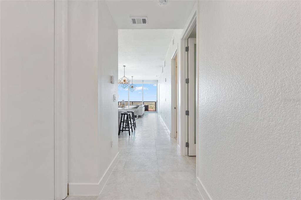 150 East Robinson Street, Unit 601 Orlando, FL 32801 - Photo 6 of 23 a hallway with a dining table and chairs