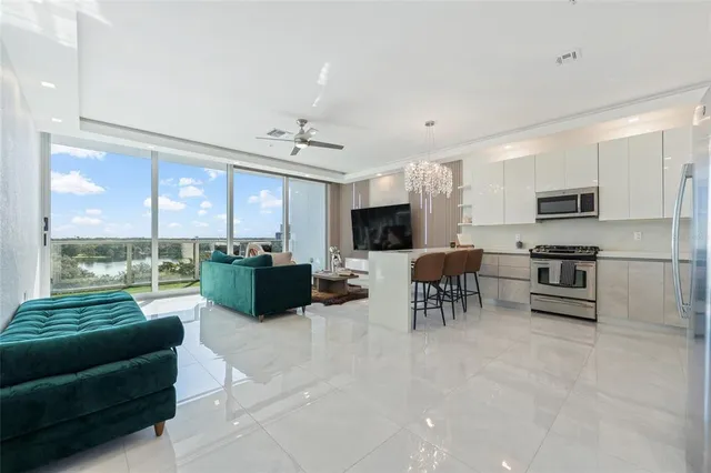 a living room with fireplace furniture and a large window