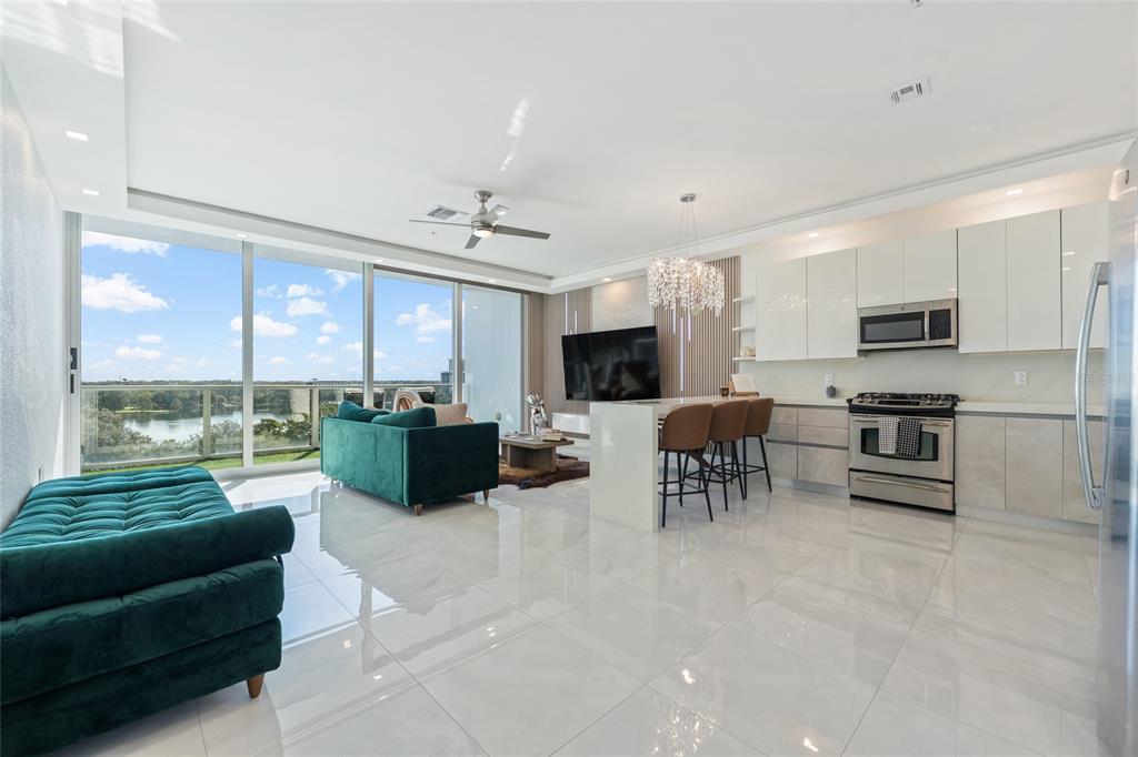 150 East Robinson Street, Unit 601 Orlando, FL 32801 - Photo 9 of 23 a living room with furniture and a flat screen tv