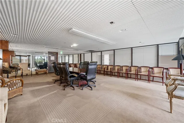 a living room with furniture a lamp and a large window