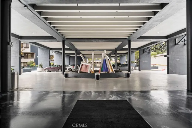 a living room with stainless steel appliances kitchen island granite countertop furniture and a flat screen tv