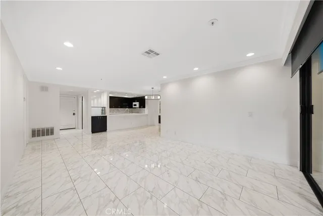 a view of kitchen with granite countertop cabinets and oven