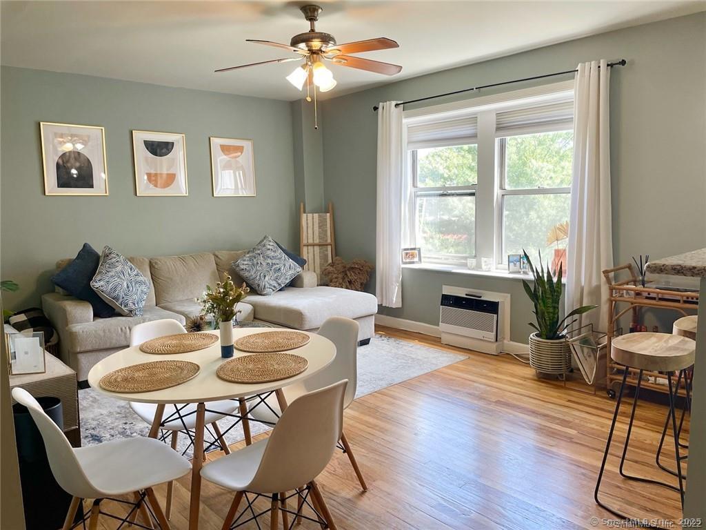 a dining room with furniture a chandelier and wooden floor