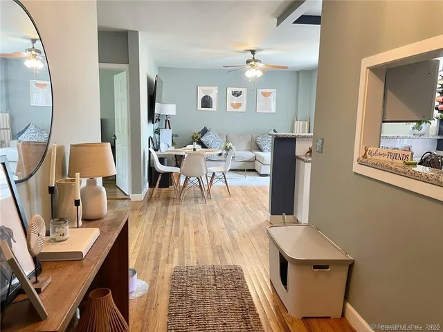 a living room with furniture and wooden floor