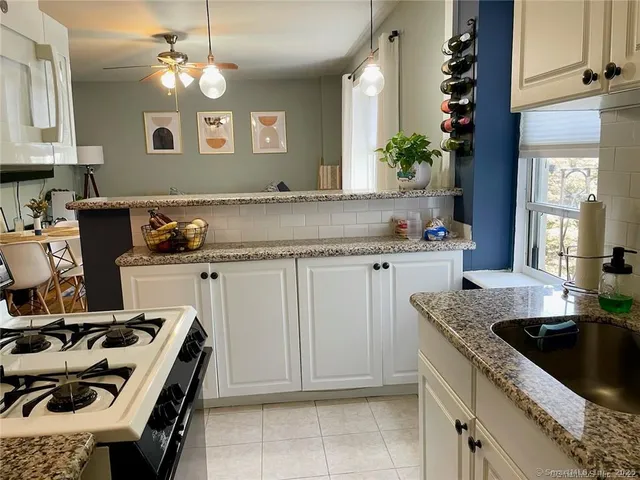a kitchen with a sink stove and cabinets