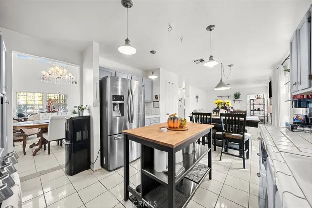 a view of a dining room and livingroom with furniture wooden floor a chandelier