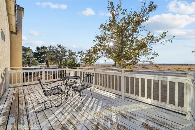 a view of balcony with wooden floor and fence