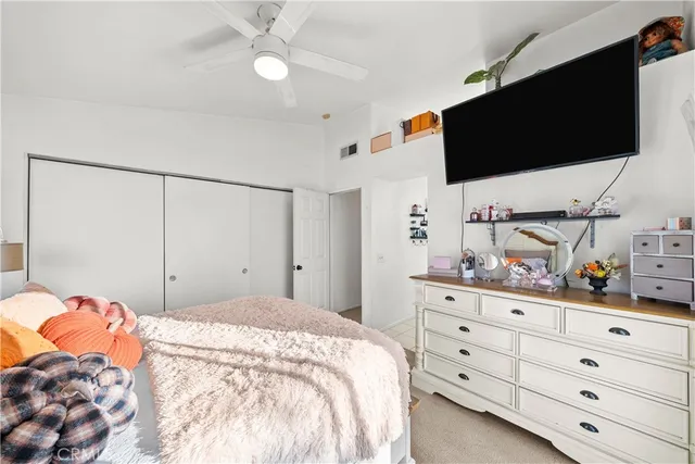 a bedroom with a bed window and flat screen tv