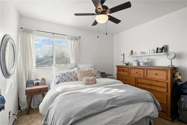 a bedroom with a large bed and a window