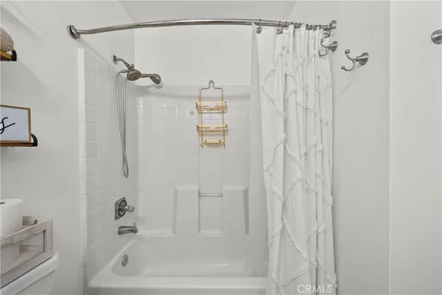 a bathroom with a shower and a bath tub