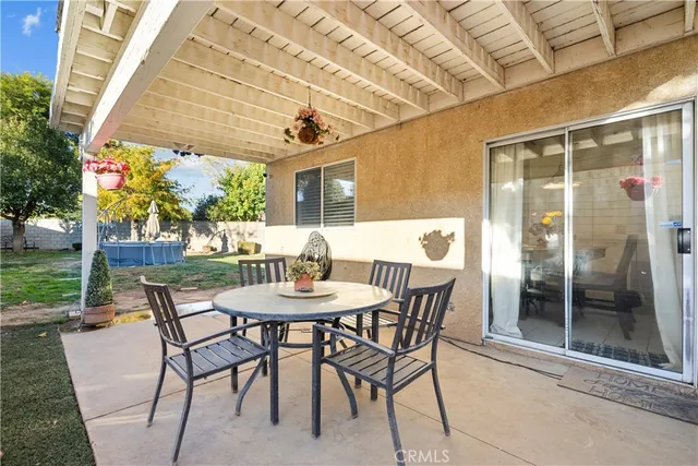 a view of a patio with a table and chairs