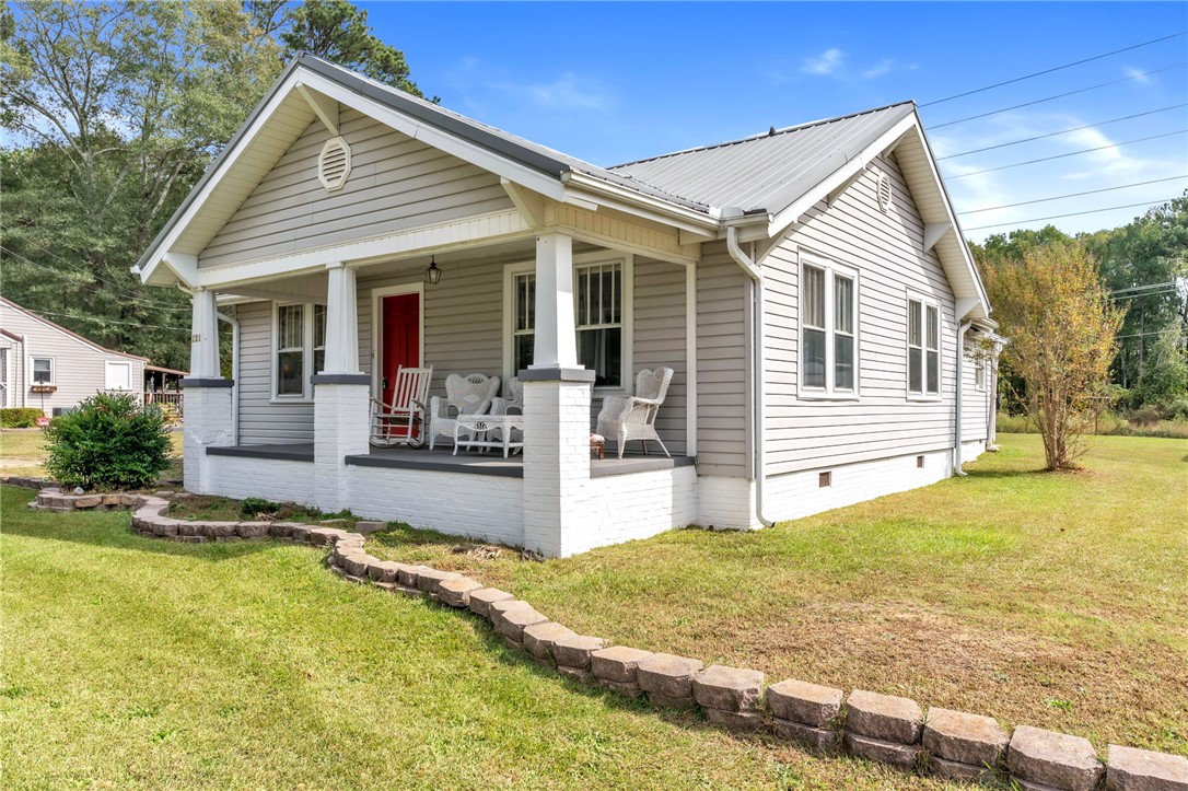 121 Ellison Street Belton, SC 29627 - Photo 2 of 30 This charming bungalow offers a welcoming porch, perfect for enjoying peaceful outdoor moments.