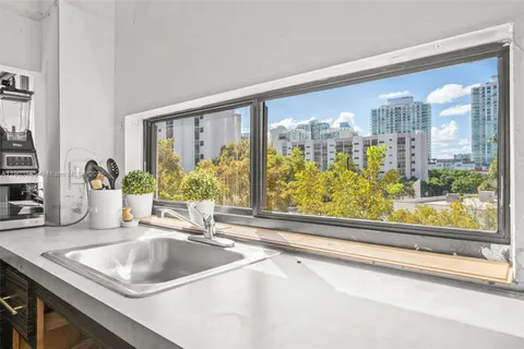 a kitchen with a sink and large window