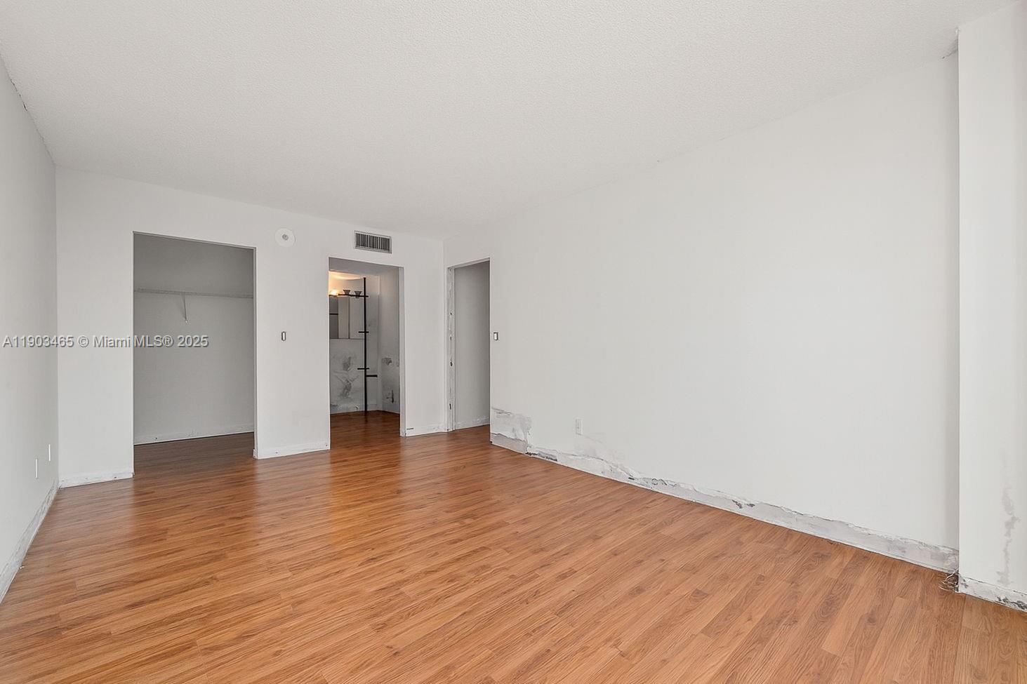 17021 North Bay Road, Unit 516 Sunny Isles Beach, FL 33160 - Photo 7 of 14 a view of an empty room and wooden floor and closet