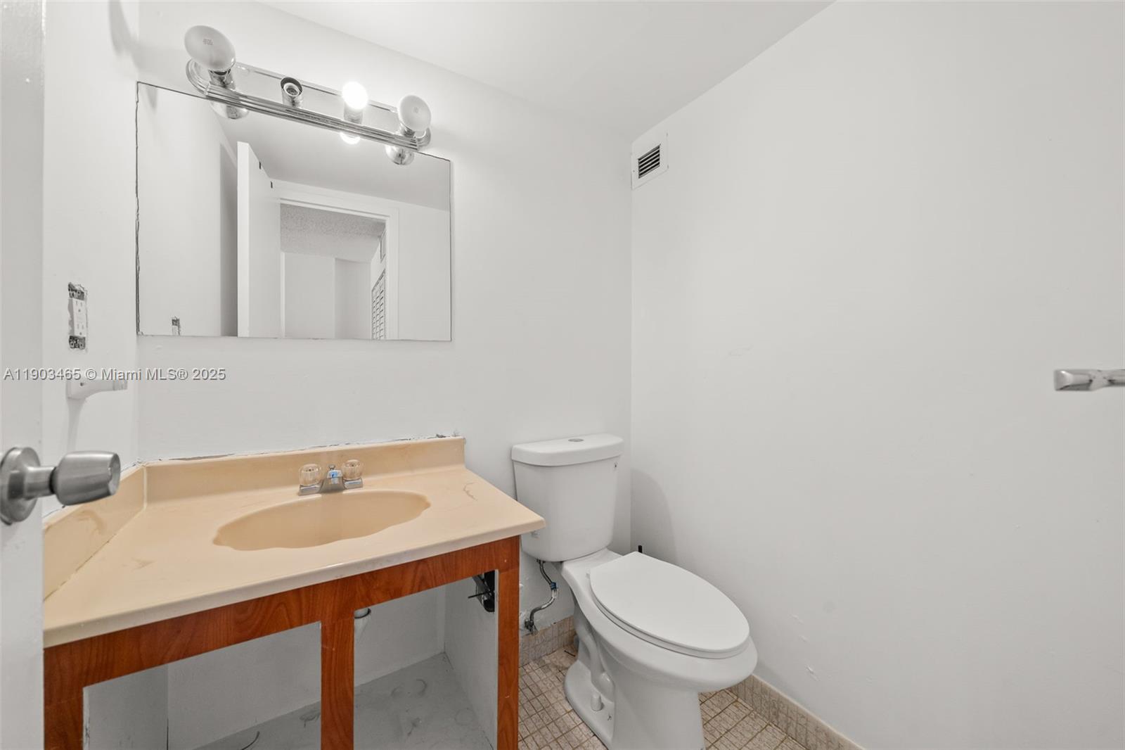 17021 North Bay Road, Unit 516 Sunny Isles Beach, FL 33160 - Photo 8 of 14 a bathroom with a sink toilet and a mirror