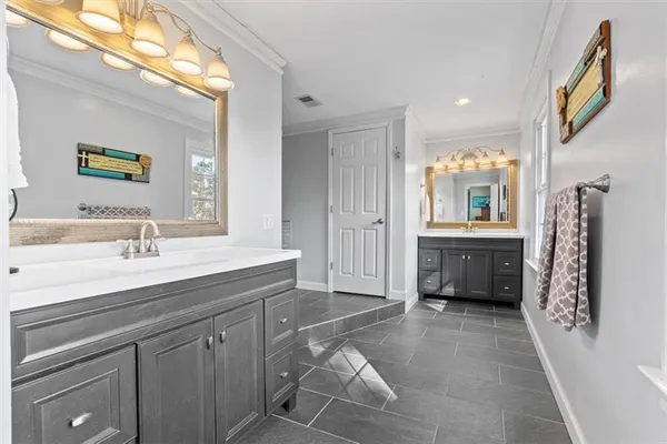 a spacious bathroom with a sink a mirror and a shower