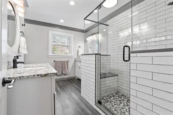 a bathroom with a granite countertop sink a toilet and shower