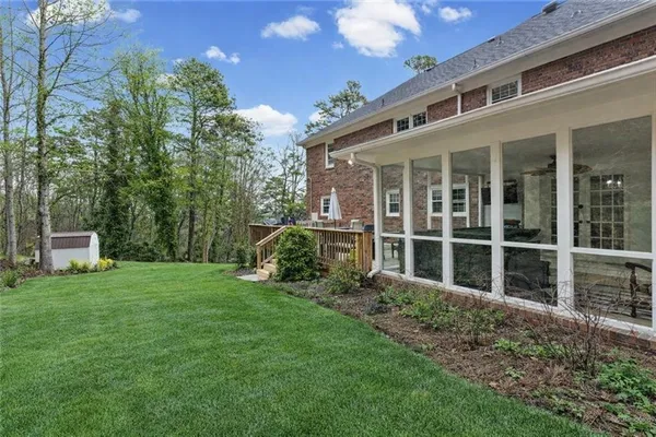 a view of a house with backyard sitting area and garden
