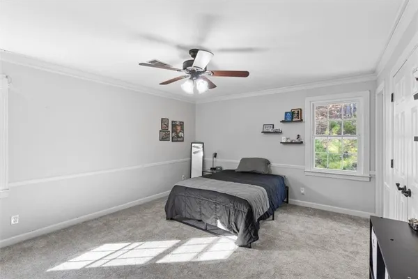 a bedroom with a bed and a window