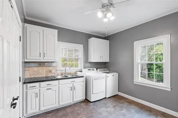 a kitchen with a sink cabinets and window