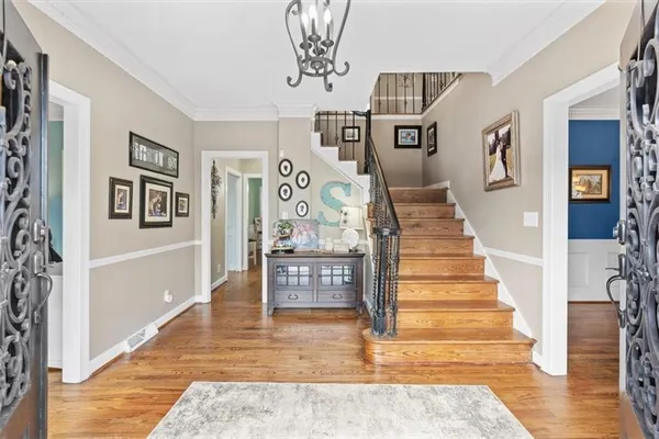 a view of entryway and hall with wooden floor