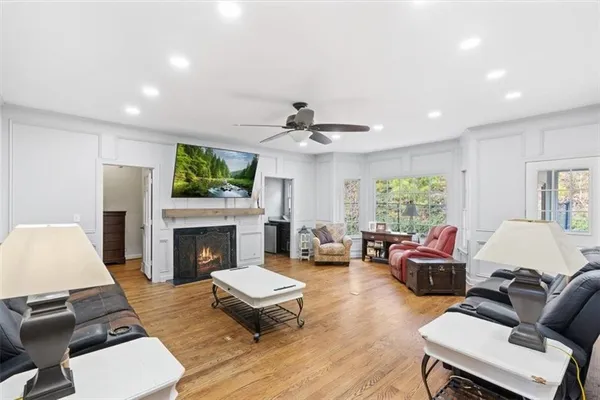 a living room with furniture a fireplace and a flat screen tv