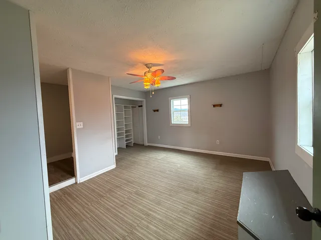 a view of a livingroom with wooden floor and a window
